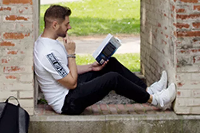 manlig student som sitter och läser